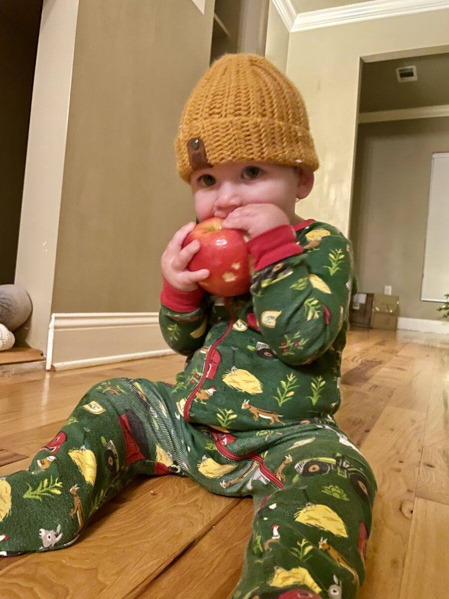Baby eating organic apple from Chelan Ranch